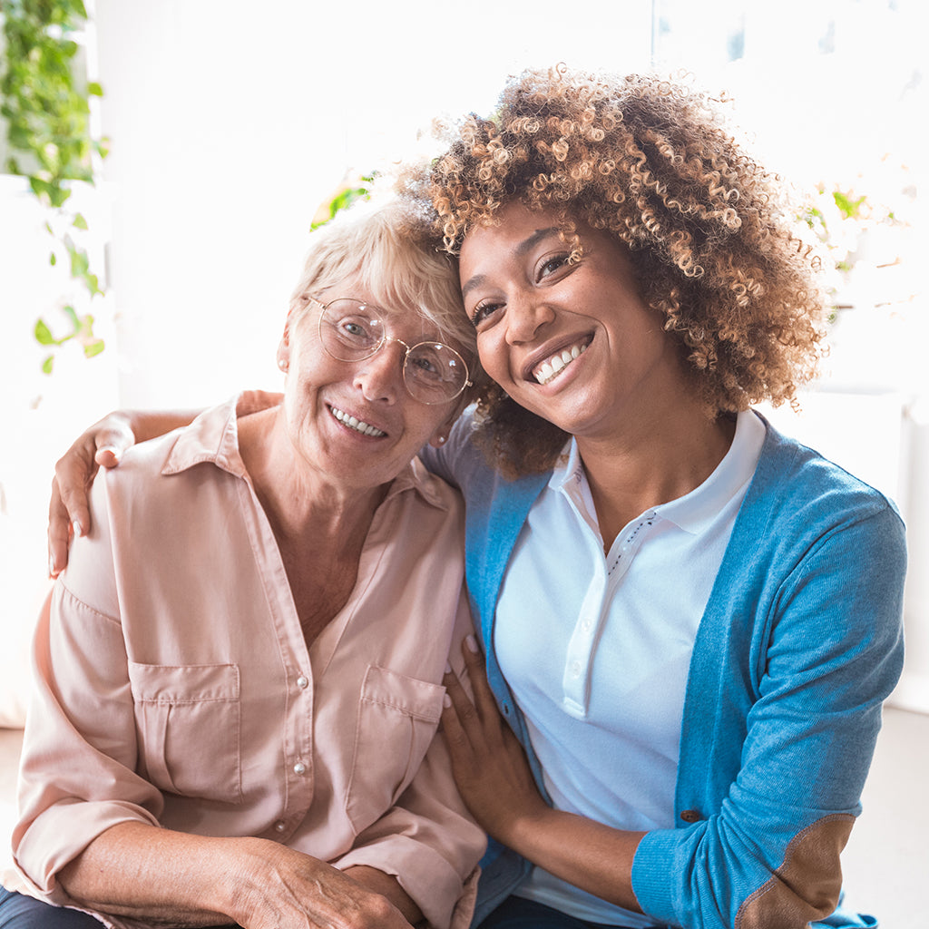 Caregiver and senior woman address home safety with grab bars